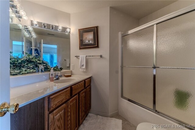 492 Regatta Bay Dr Unit 2D, Lake Ozark, MO 65049 - full bath featuring vanity, bath / shower combo with glass door, and tile patterned flooring