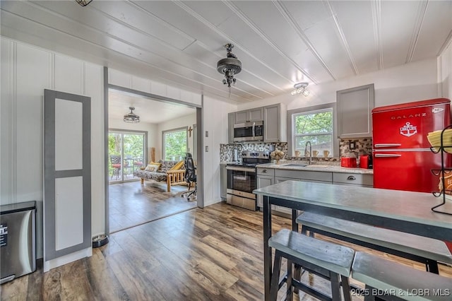 54 White Rock Ln, Sunrise Beach, MO 65079 - kitchen with appliances with stainless steel finishes, gray cabinetry, healthy amount of natural light, and tasteful backsplash