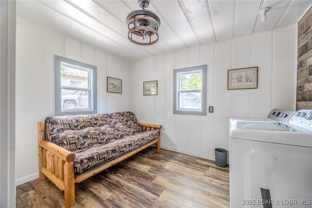 54 White Rock Ln, Sunrise Beach, MO 65079 - living area with healthy amount of natural light, independent washer and dryer, wood finished floors, and a decorative wall