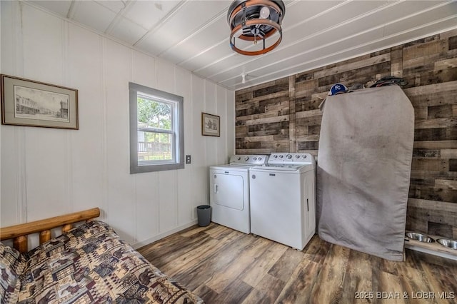 54 White Rock Ln, Sunrise Beach, MO 65079 - laundry room featuring washer and dryer and wood finished floors