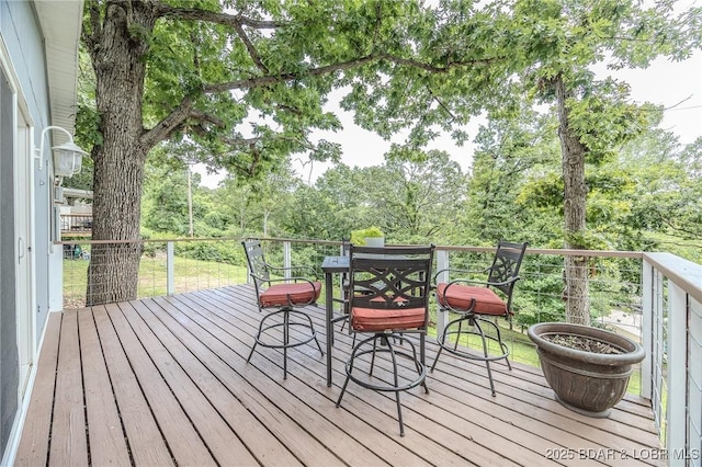 54 White Rock Ln, Sunrise Beach, MO 65079 - wooden terrace featuring outdoor dining space and view of wooded area
