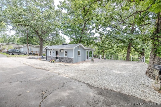 54 White Rock Ln, Sunrise Beach, MO 65079 - view of front of property featuring stone siding and covered porch