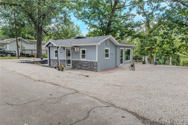 54 White Rock Ln, Sunrise Beach, MO 65079 - view of front of home with stone siding, a shingled roof, and board and batten siding