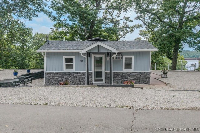 54 White Rock Ln, Sunrise Beach, MO 65079 - view of front of property featuring stone siding, roof with shingles, and board and batten siding