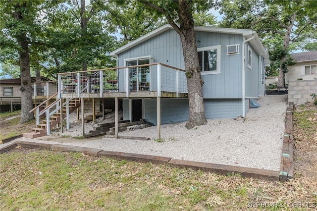 54 White Rock Ln, Sunrise Beach, MO 65079 - back of house featuring a deck and stairs