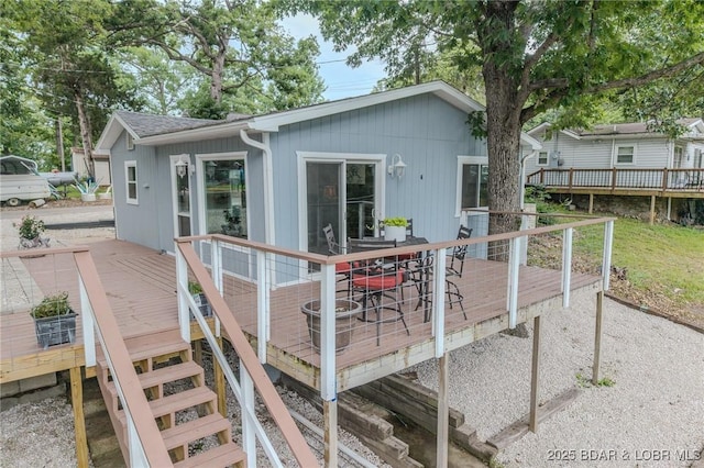 54 White Rock Ln, Sunrise Beach, MO 65079 - rear view of property with a wooden deck and outdoor dining space