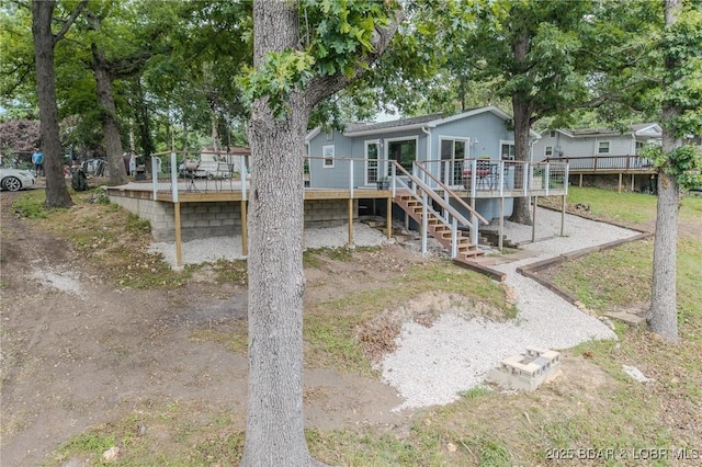 54 White Rock Ln, Sunrise Beach, MO 65079 - back of property featuring a wooden deck and stairs