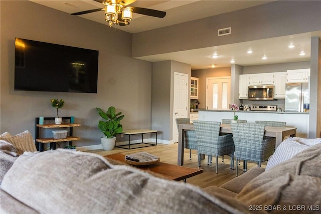 46 Aqua Fin Dr Unit 4A, Lake Ozark, MO 65049 - living room featuring light wood-style floors, a ceiling fan, and recessed lighting