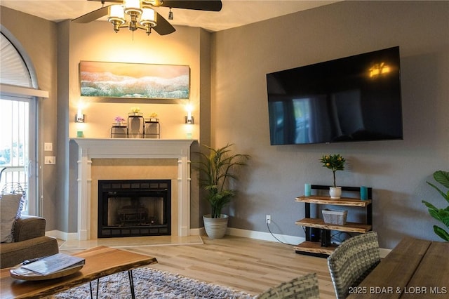 46 Aqua Fin Dr Unit 4A, Lake Ozark, MO 65049 - living room with wood finished floors, a ceiling fan, and a fireplace with raised hearth
