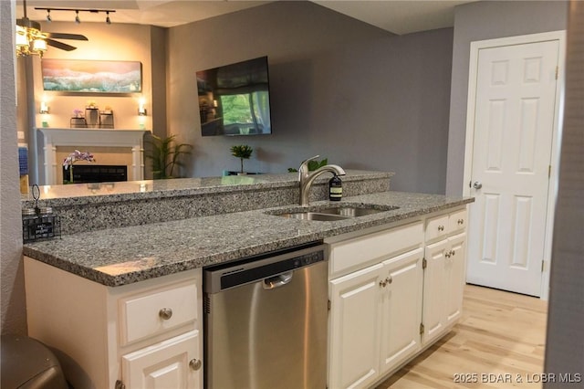 46 Aqua Fin Dr Unit 4A, Lake Ozark, MO 65049 - kitchen with dishwasher, light wood-type flooring, dark stone counters, white cabinetry, and ceiling fan