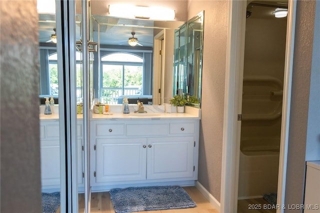 46 Aqua Fin Dr Unit 4A, Lake Ozark, MO 65049 - full bathroom featuring ceiling fan, vanity, a textured wall, and wood finished floors