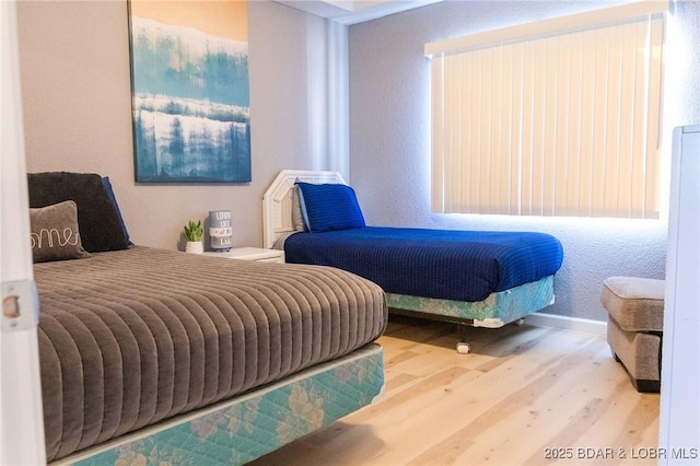 46 Aqua Fin Dr Unit 4A, Lake Ozark, MO 65049 - bedroom featuring wood finished floors and a textured wall