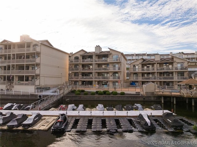 46 Aqua Fin Dr Unit 4A, Lake Ozark, MO 65049 - view of apartment building / complex featuring uncovered parking and a water view