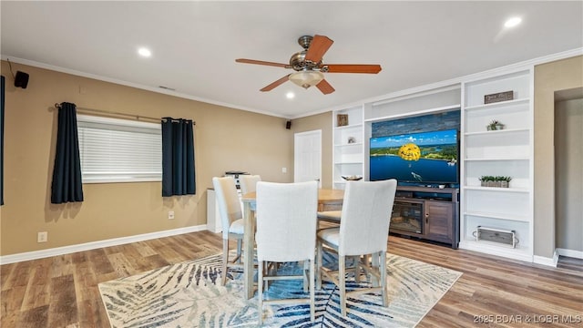 161 Tanglewood Dr, Camdenton, MO 65020 - dining space featuring ceiling fan, wood finished floors, built in features, crown molding, and recessed lighting