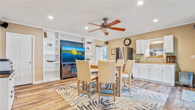 161 Tanglewood Dr, Camdenton, MO 65020 - dining room featuring ornamental molding, ceiling fan, light wood-style floors, recessed lighting, and built in shelves
