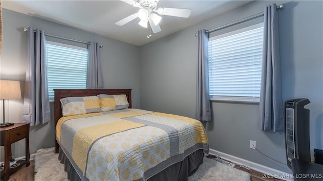 161 Tanglewood Dr, Camdenton, MO 65020 - bedroom featuring multiple windows, ceiling fan, and wood finished floors