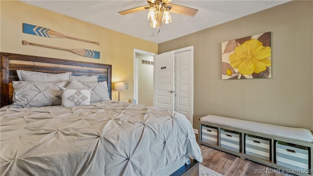 161 Tanglewood Dr, Camdenton, MO 65020 - bedroom with wood finished floors, a closet, and a ceiling fan
