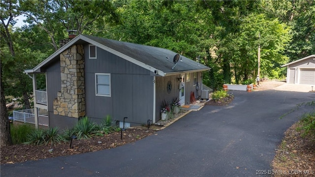161 Tanglewood Dr, Camdenton, MO 65020 - view of front of house featuring a chimney and a detached garage