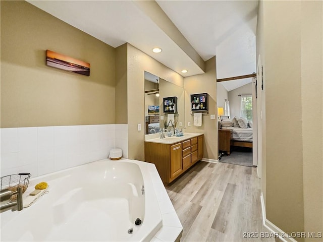 110 Golf View Dr, Camdenton, MO 65020 - full bath featuring ensuite bath, vanity, a garden tub, wood finished floors, and recessed lighting