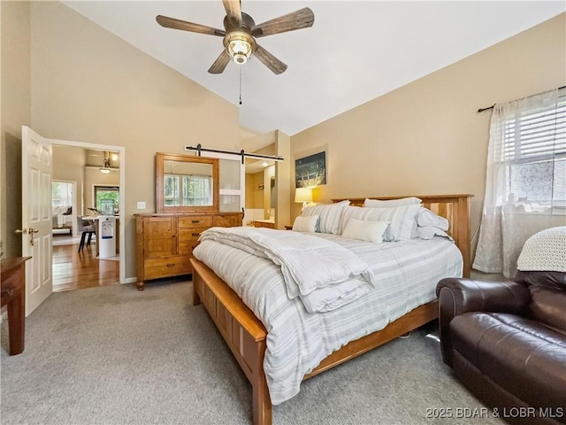 110 Golf View Dr, Camdenton, MO 65020 - bedroom featuring multiple windows, carpet floors, high vaulted ceiling, a barn door, and ceiling fan