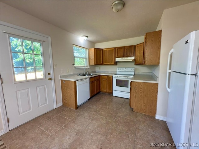 868 E St, Lebanon, MO 65536 - kitchen featuring white appliances, brown cabinets, light countertops, and under cabinet range hood