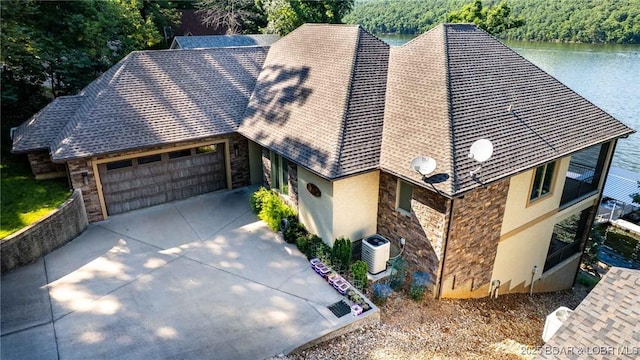 87 Glenmeadows Ct, Linn Creek, MO 65052 - view of front of home featuring stone siding, an attached garage, and stucco siding