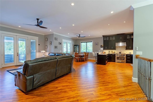 87 Glenmeadows Ct, Linn Creek, MO 65052 - living area featuring light wood finished floors, recessed lighting, french doors, crown molding, and ceiling fan