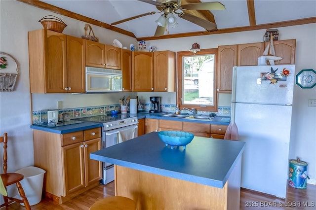 4230 Fox Hollow Ln, Stover, MO 65078 - kitchen featuring white appliances, vaulted ceiling, light wood-style flooring, ceiling fan, and a center island