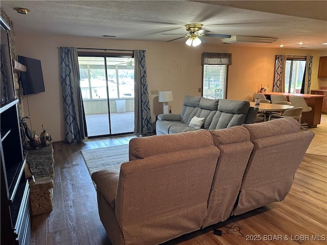 30024 Hawaii Rd, Gravois Mills, MO 65037 - living room with light wood finished floors, ceiling fan, and a textured ceiling