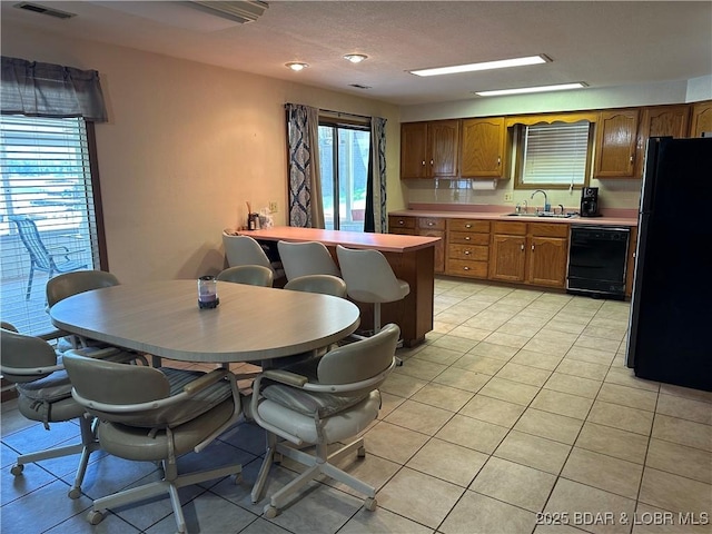 30024 Hawaii Rd, Gravois Mills, MO 65037 - kitchen featuring black appliances, light countertops, healthy amount of natural light, and light tile patterned floors