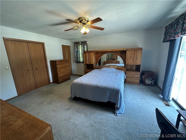 30024 Hawaii Rd, Gravois Mills, MO 65037 - bedroom with light carpet, ceiling fan, a textured ceiling, and a closet