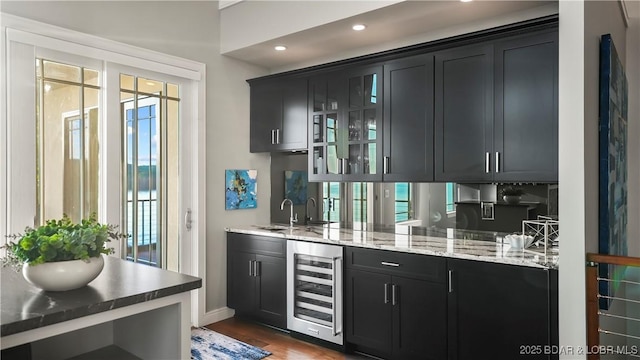 777 Malibu Rd, Osage Beach, MO 65065 - indoor wet bar with beverage cooler, dark wood finished floors, and recessed lighting