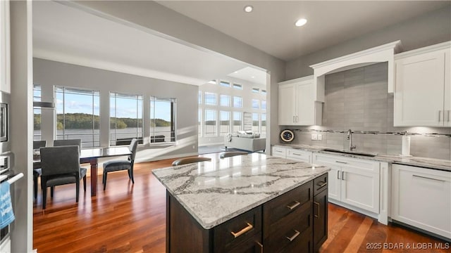 777 Malibu Rd, Osage Beach, MO 65065 - kitchen with plenty of natural light, backsplash, white cabinetry, light stone countertops, and recessed lighting