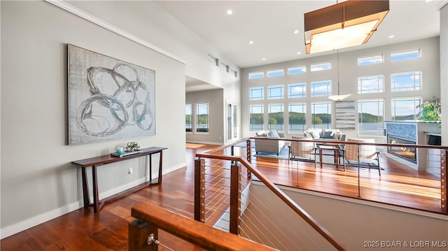 777 Malibu Rd, Osage Beach, MO 65065 - hall featuring an upstairs landing, recessed lighting, wood finished floors, and a towering ceiling