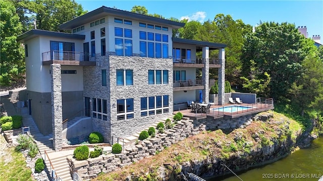 777 Malibu Rd, Osage Beach, MO 65065 - rear view of property with a balcony, stone siding, stairs, and a patio