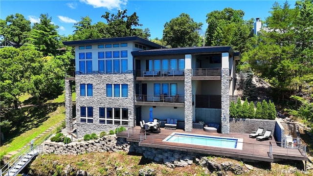 777 Malibu Rd, Osage Beach, MO 65065 - back of house featuring an outdoor living space, a balcony, an outdoor pool, and stone siding