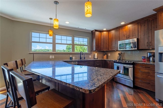30310 Old Peony Rd, Gravois Mills, MO 65037 - kitchen featuring stainless steel appliances, a peninsula, dark wood-style flooring, decorative backsplash, and crown molding