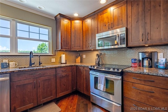 30310 Old Peony Rd, Gravois Mills, MO 65037 - kitchen with stainless steel appliances, dark wood-type flooring, stone countertops, crown molding, and decorative backsplash