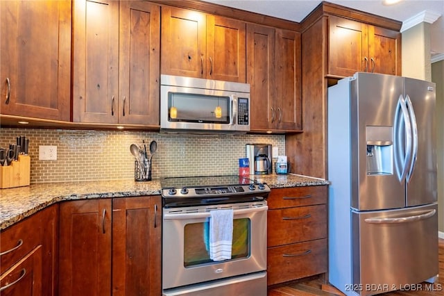 30310 Old Peony Rd, Gravois Mills, MO 65037 - kitchen featuring stainless steel appliances, backsplash, light stone counters, brown cabinets, and crown molding