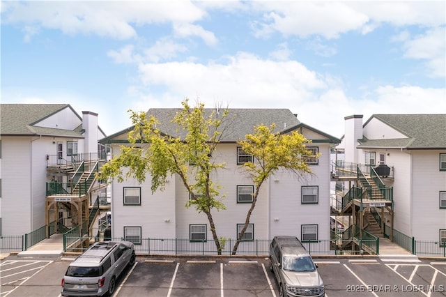 708 Harbour Towne Dr Unit E-708, Lake Ozark, MO 65049 - view of property with stairway and uncovered parking