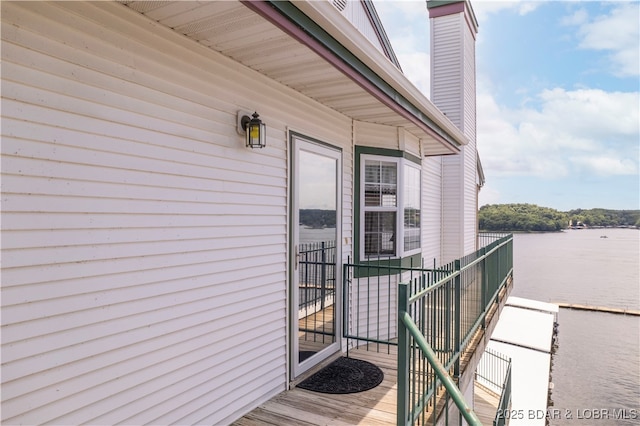 708 Harbour Towne Dr Unit E-708, Lake Ozark, MO 65049 - doorway to property featuring a chimney and a water view