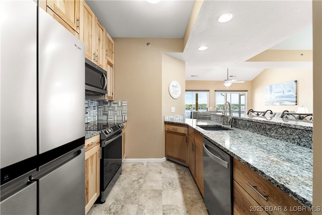 708 Harbour Towne Dr Unit E-708, Lake Ozark, MO 65049 - kitchen featuring appliances with stainless steel finishes, stone counters, tasteful backsplash, ceiling fan, and light brown cabinets