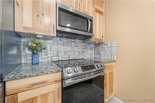 708 Harbour Towne Dr Unit E-708, Lake Ozark, MO 65049 - kitchen with stainless steel appliances, light brown cabinets, decorative backsplash, and stone counters