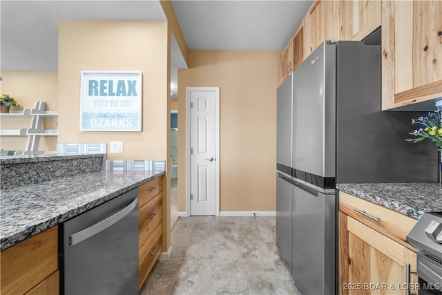708 Harbour Towne Dr Unit E-708, Lake Ozark, MO 65049 - kitchen with stainless steel appliances, stone counters, and light brown cabinetry
