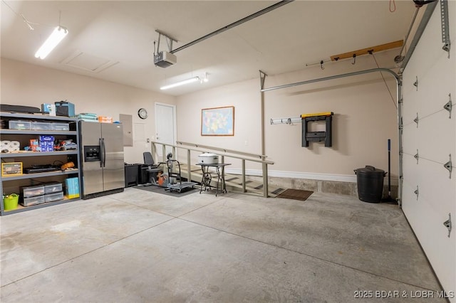 4331 Sunset Dr Unit B, Osage Beach, MO 65065 - garage featuring stainless steel refrigerator with ice dispenser and a garage door opener
