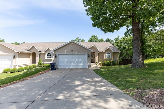 4331 Sunset Dr Unit B, Osage Beach, MO 65065 - ranch-style home with stucco siding, a garage, concrete driveway, and a front lawn