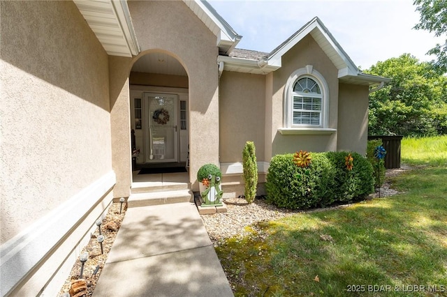 4331 Sunset Dr Unit B, Osage Beach, MO 65065 - property entrance with stucco siding and a lawn