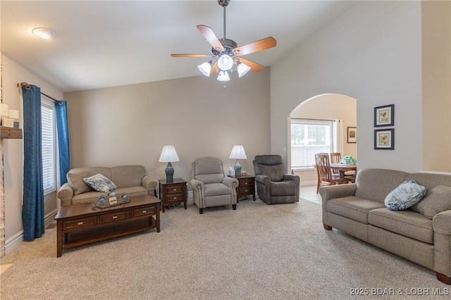 4331 Sunset Dr Unit B, Osage Beach, MO 65065 - carpeted living area with arched walkways, ceiling fan, and vaulted ceiling