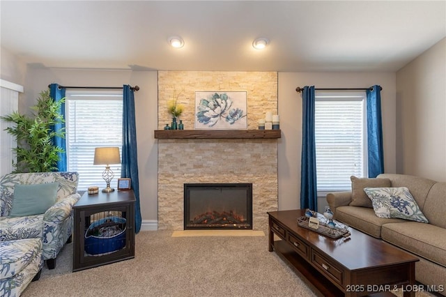 4331 Sunset Dr Unit B, Osage Beach, MO 65065 - carpeted living room with healthy amount of natural light and a stone fireplace