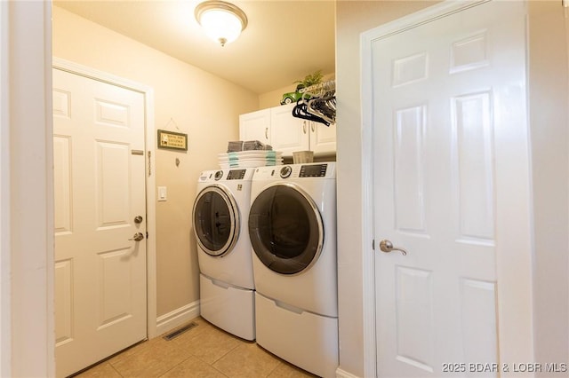 4331 Sunset Dr Unit B, Osage Beach, MO 65065 - washroom featuring cabinet space, washer and dryer, and light tile patterned floors